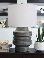Distressed black poly table lamp with white drum shade and ribbed base