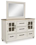 Antique white dresser with framed mirror and cabinet doors with metal pulls