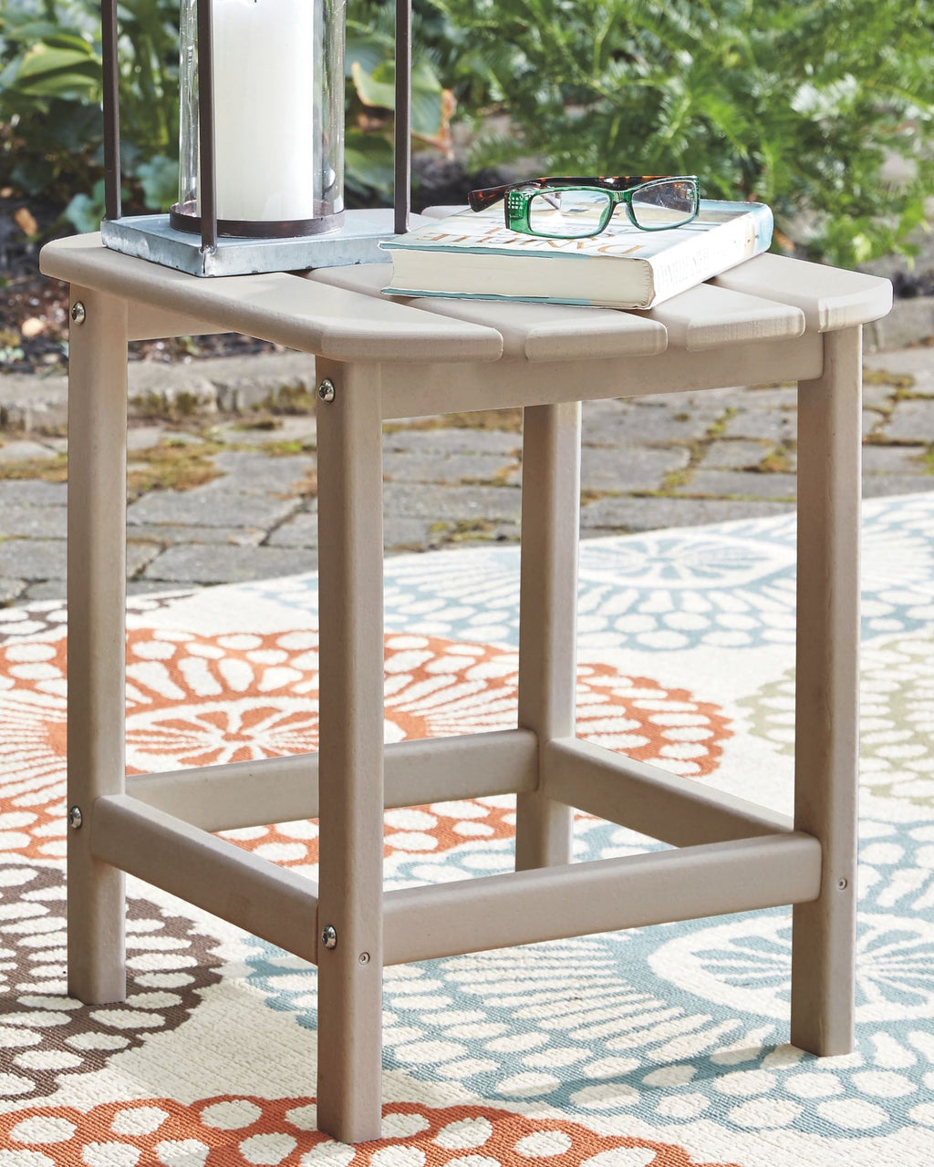 White outdoor side table with lower shelf and flat top surface