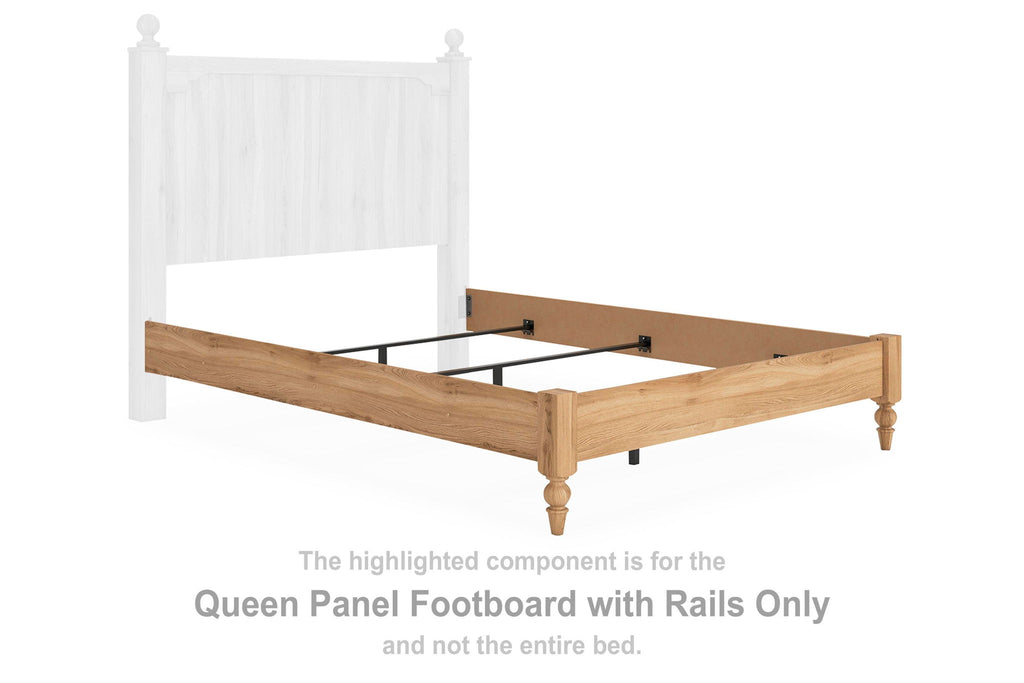 Warm brown wood queen panel footboard with side rails and posts