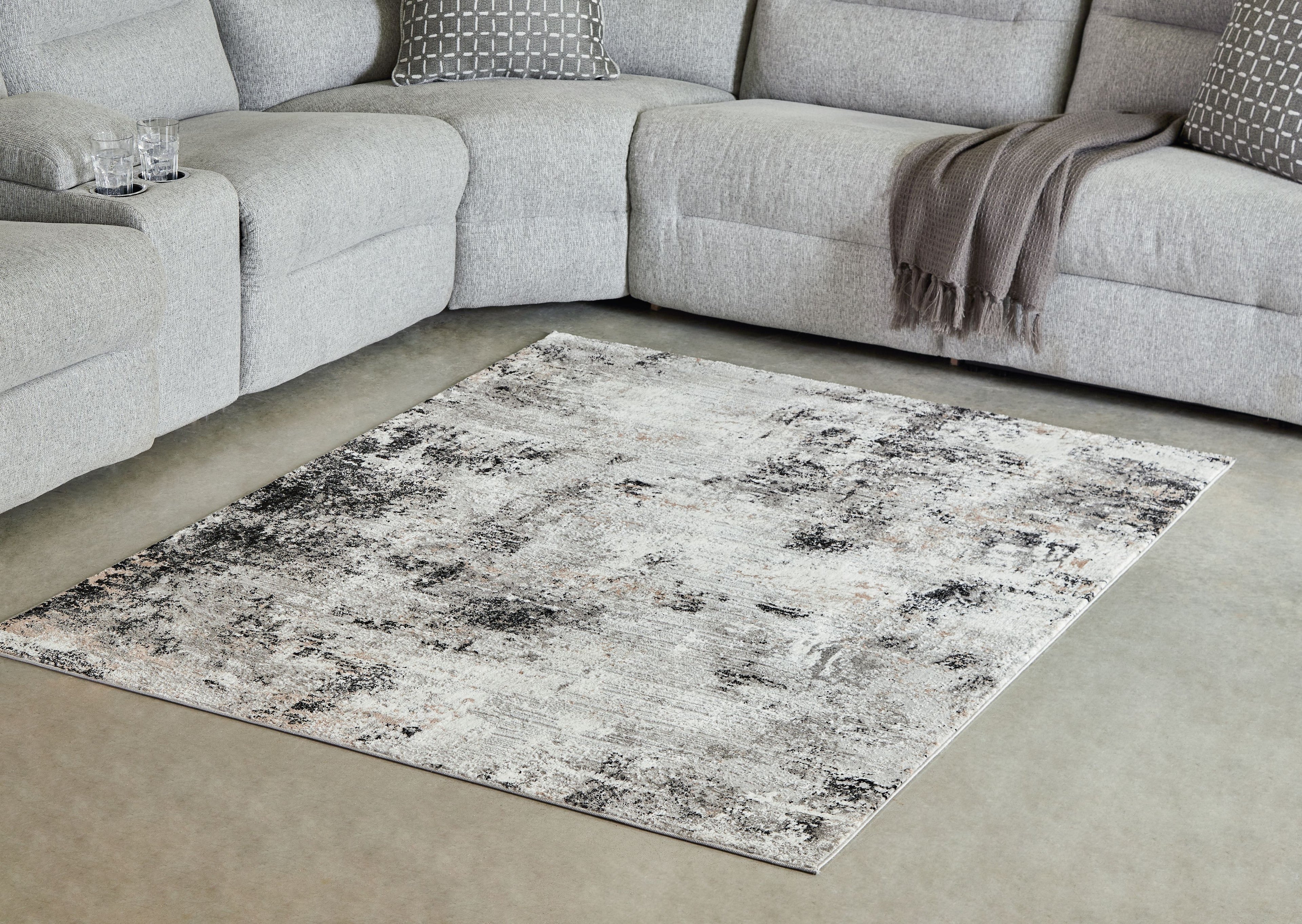 Black and gray distressed abstract area rug with wide border
