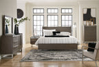 King panel bed in gray-brown wood with striped bedding and headboard rails