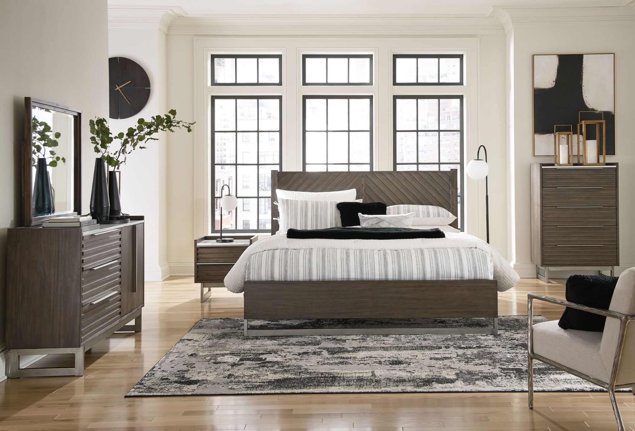 King panel bed in gray-brown wood with striped bedding and headboard rails
