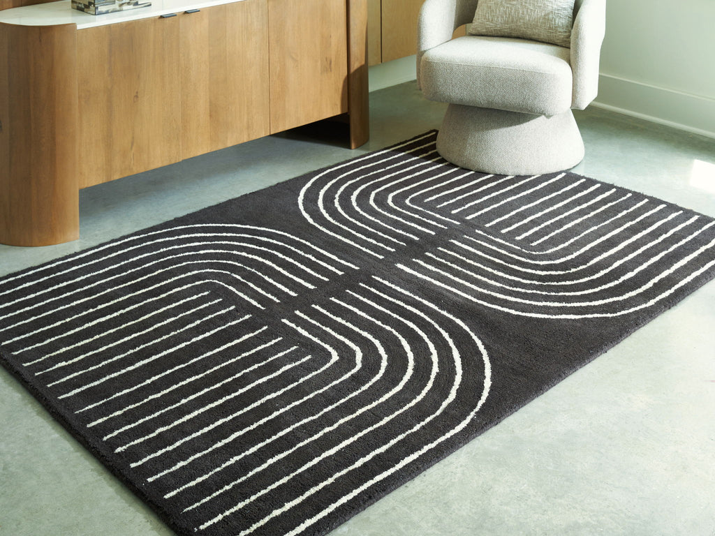 Eldonmore rug with black ground and white contour lines in bold V-shaped curves.