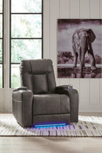 Dark power recliner chair with tall back and adjustable headrest, upright