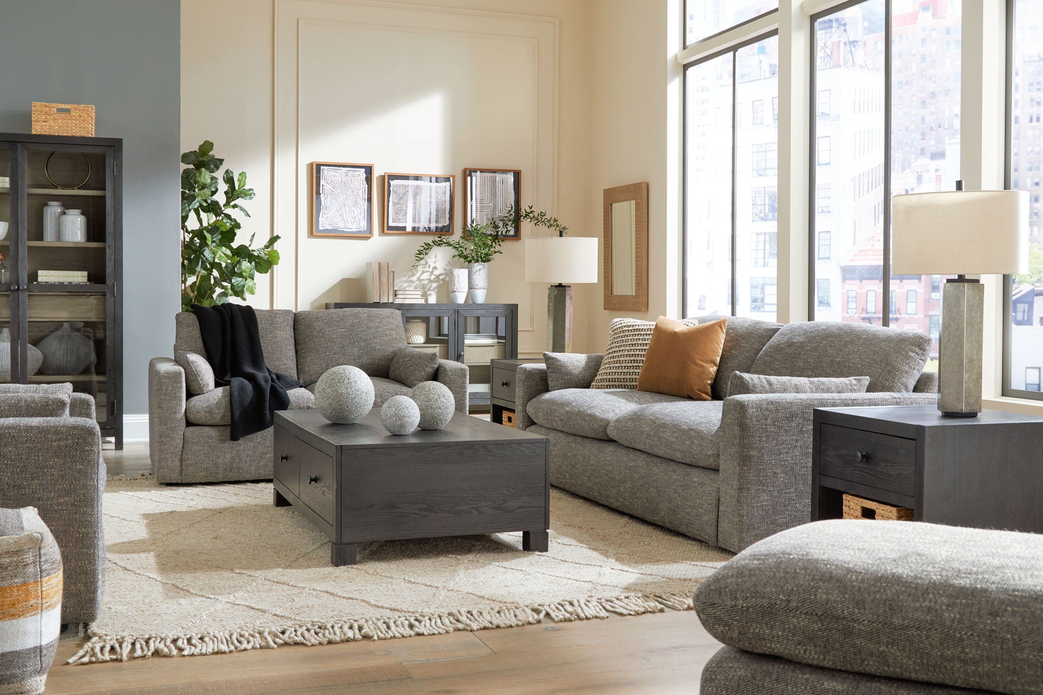 Gray sectional-style living room set with sofa, loveseat, and coordinating ottoman