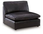 Black armless chair with padded seat and back, square side panels, and low legs