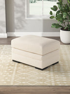 Light beige rectangular ottoman with cushioned top and black legs