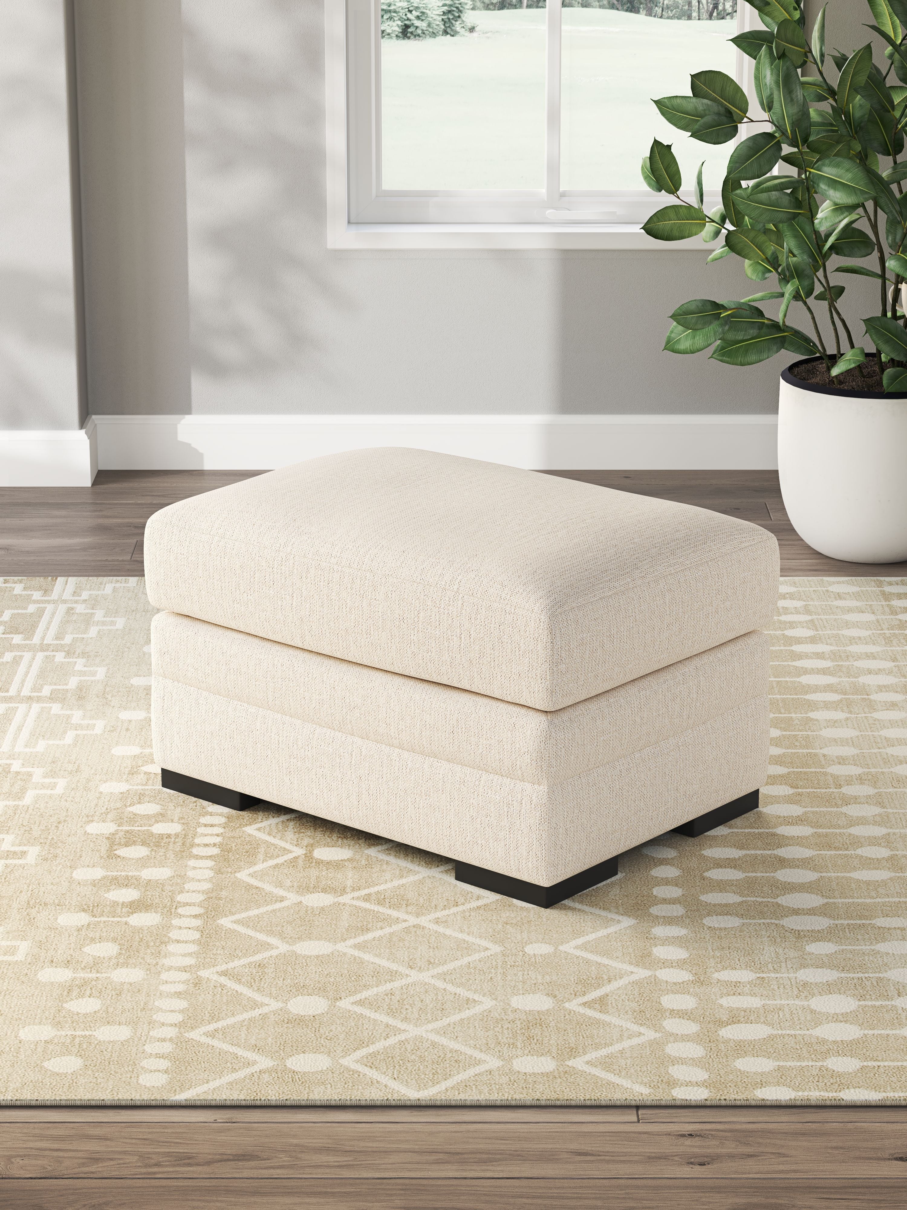 Light beige rectangular ottoman with cushioned top and black legs