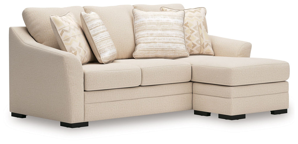 Queen sofa chaise sleeper in light beige fabric with throw pillows, chaise extended left