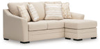 Queen sofa chaise sleeper in light beige fabric with throw pillows, chaise extended left