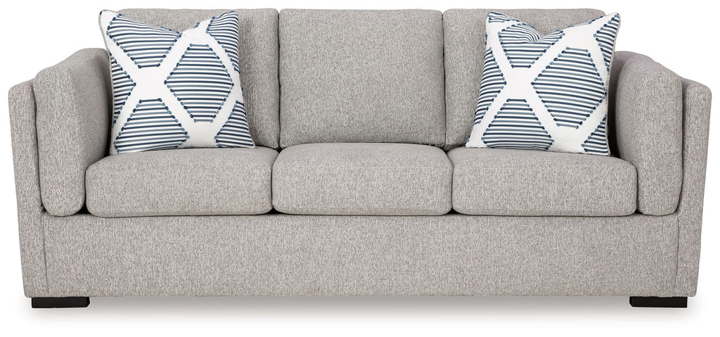 Pewter fabric sofa with two patterned throw pillows and three seat cushions