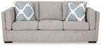 Pewter fabric sofa with two patterned throw pillows and three seat cushions