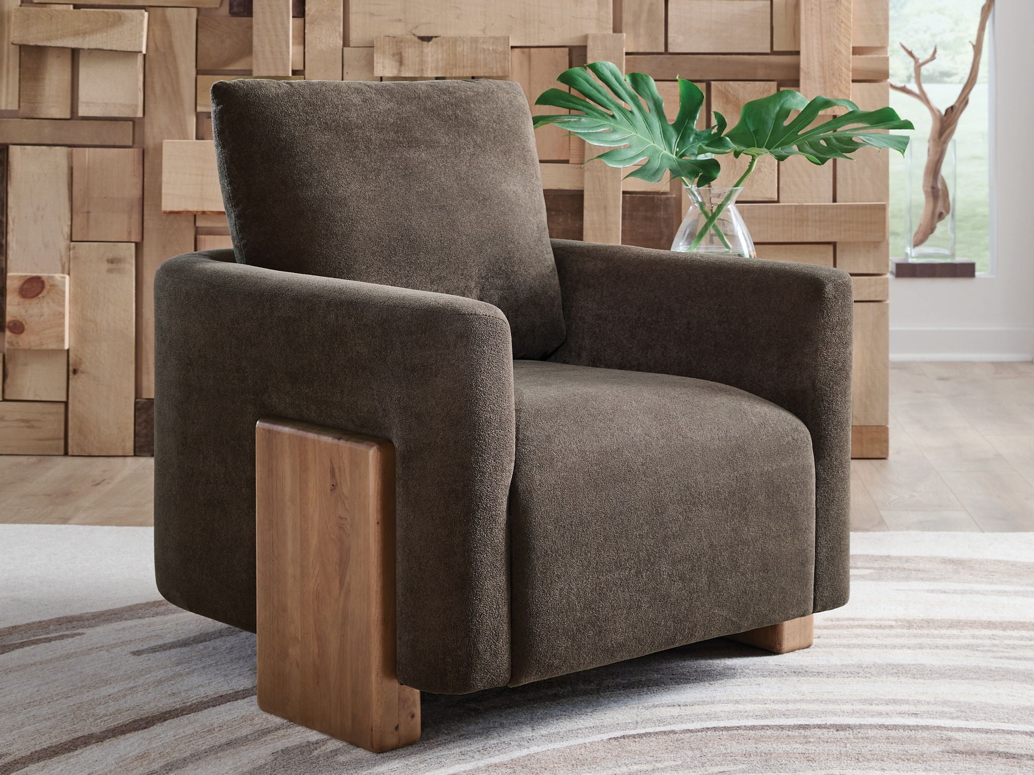 Brown accent chair with high backrest, padded arms, and light wood sides