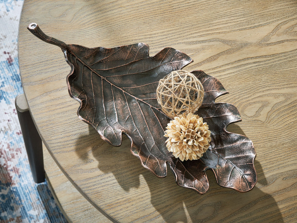 Antique copper leaf-shaped sculpture tray on wood with twine ball and beige flower