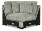 Light gray wedge sofa with ribbed fabric, rolled arms, and tufted back cushions