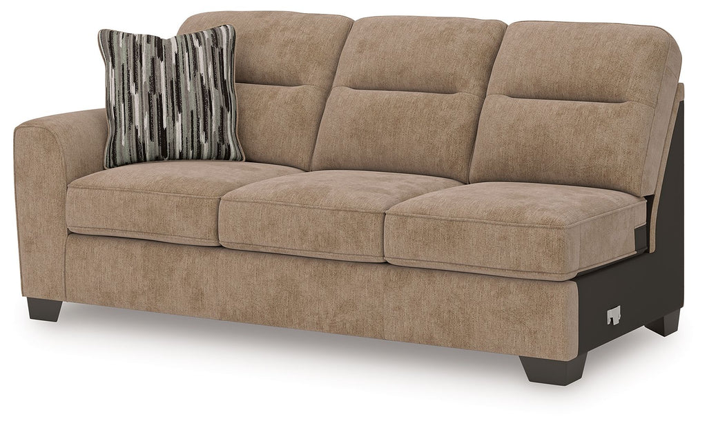 Mocha-toned upholstered sofa with tufted cushions, striped pillow, and dark legs