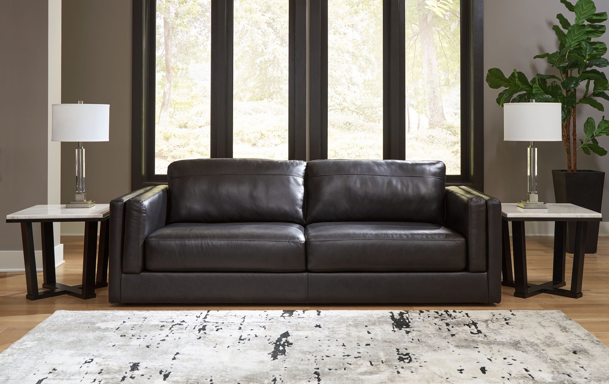 Black leather sofa with two seat cushions and square armrests