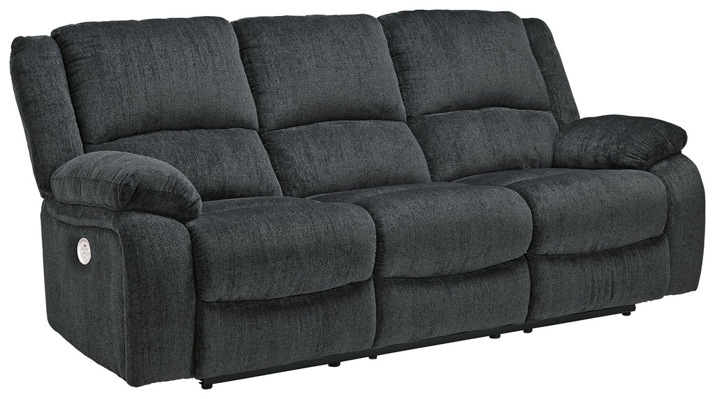 Draycoll reclining sofa in slate with tufted cushions, track arms, and reclining head support