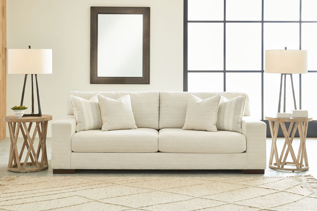 Light beige living room sofa with three throw pillows