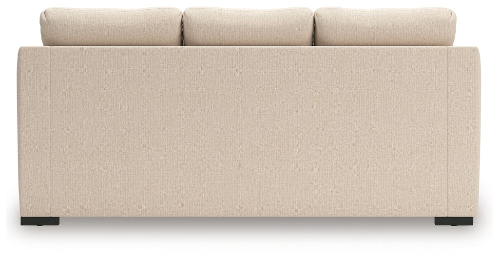 Light beige sofa chaise back view with smooth upholstery and squared armrests.