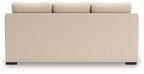 Light beige sofa chaise back view with smooth upholstery and squared armrests.