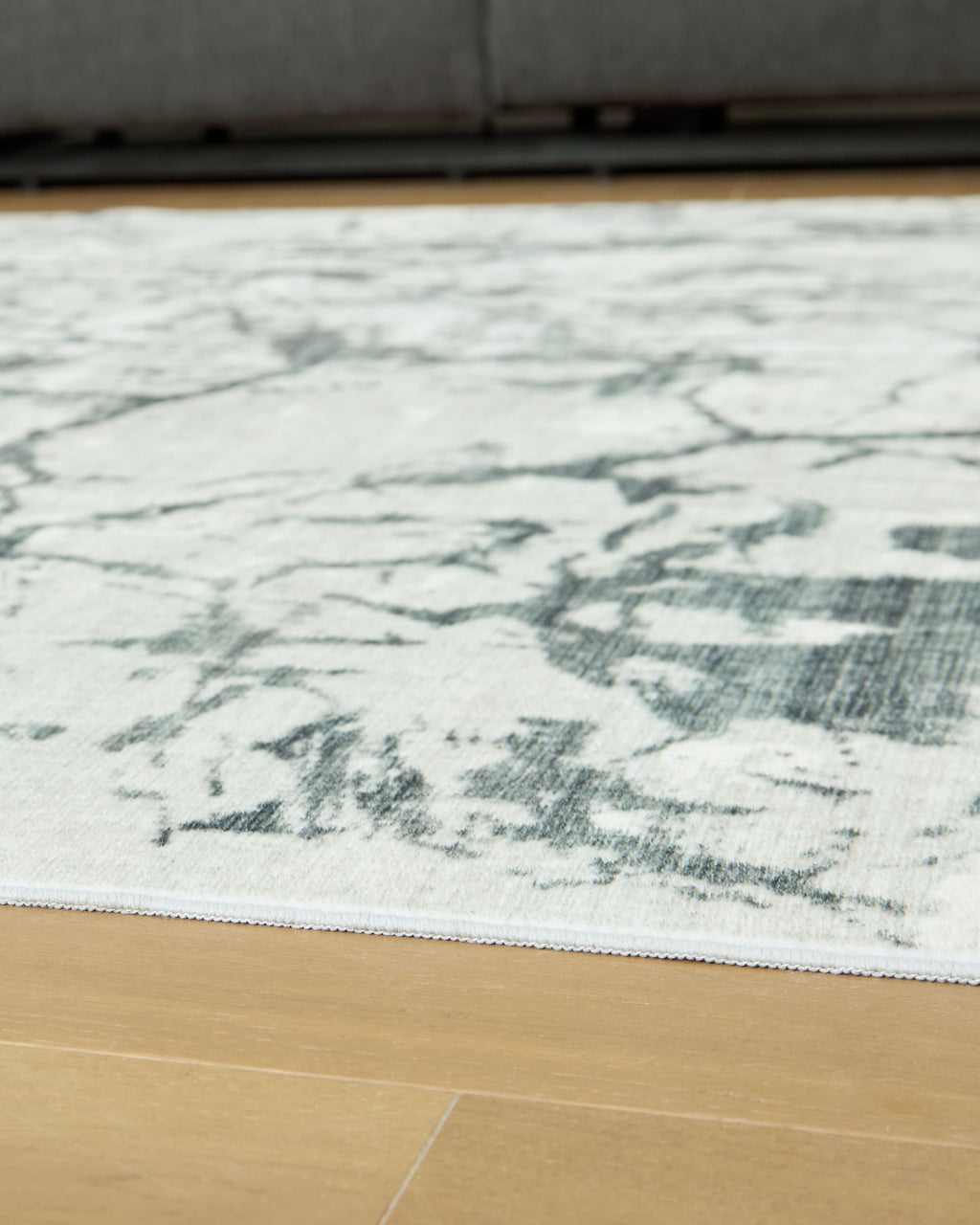 Washable rug, beige with distressed marble pattern in gray and muted green