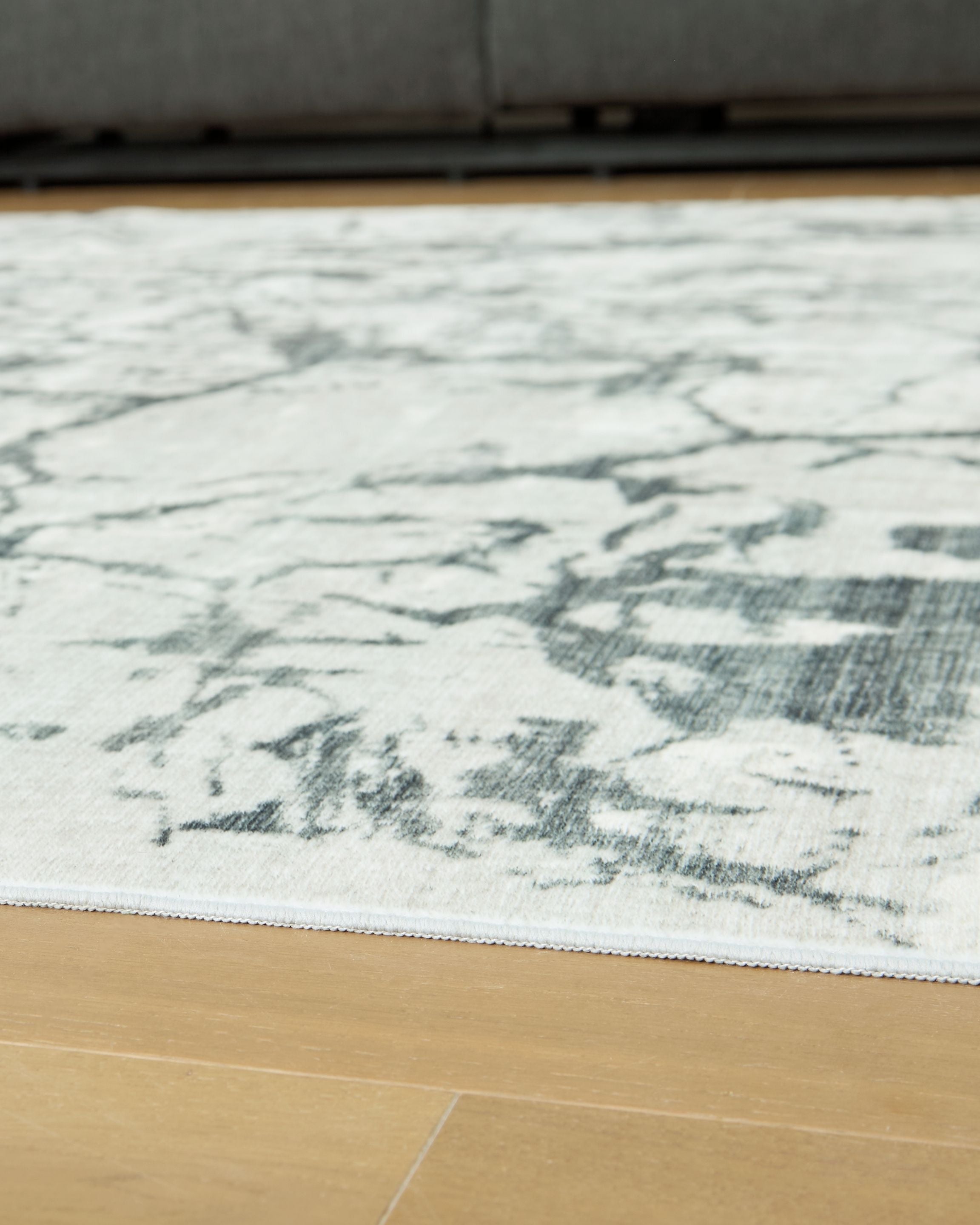 Washable rug, beige with distressed marble pattern in gray and muted green