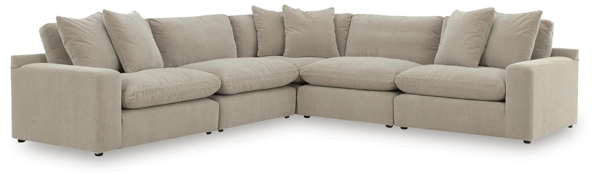 Light gray sectional sofa with wide seats, square arms, and tall back cushions with pillows.