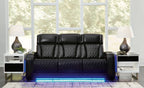 Black power reclining sofa with quilted upholstery and three padded headrests