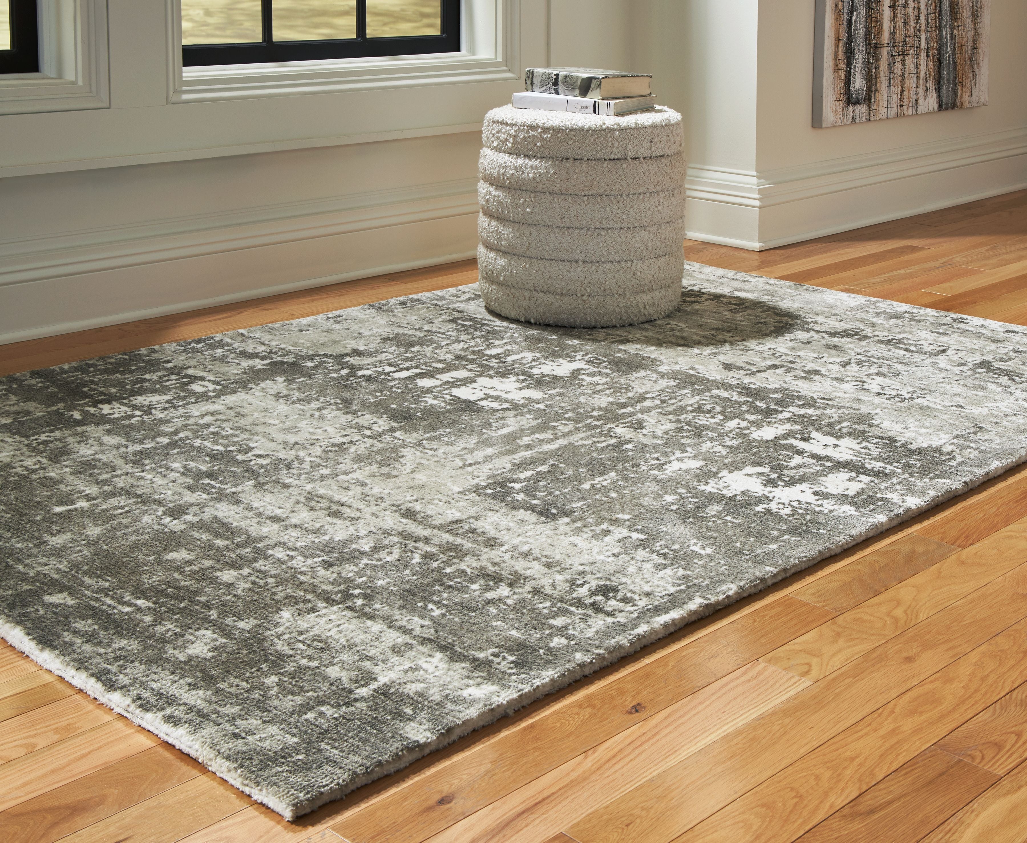 Dark gray area rug with distressed pattern, flatwoven look, and textured surface