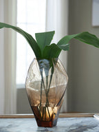 Ewart glass vase with green leaves, faceted amber tint and wide base