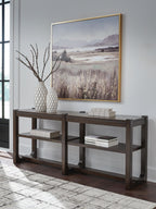 Dark brown sofa table with two shelves and decorative items on top