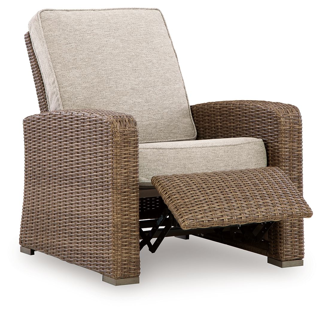 Wicker recliner chair with beige cushions and extended footrest