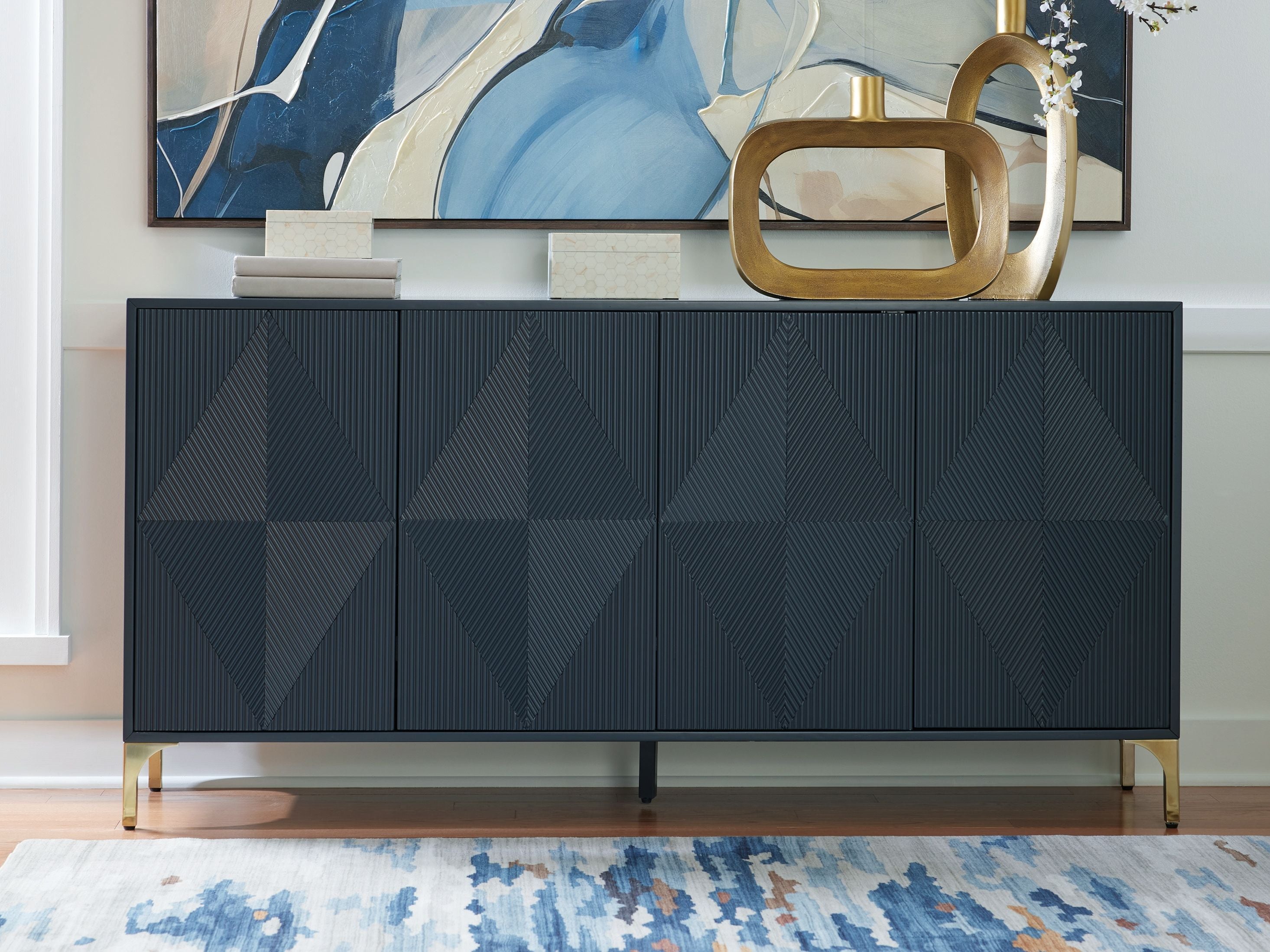 Dark blue accent cabinet with geometric diamond-pattern door panels and gold-tone legs