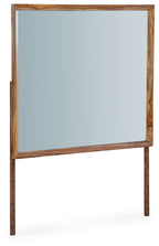 Brown wooden bedroom mirror with rectangular frame and reflective glass