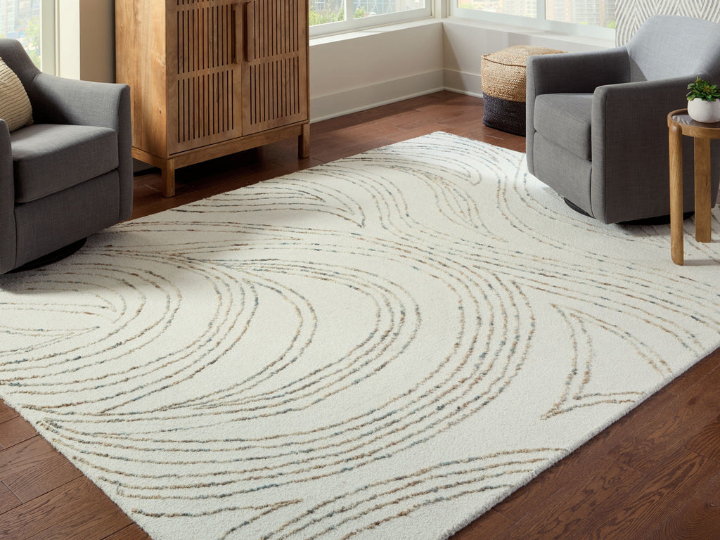 Deenbury rug in off-white with beige and gray swirl design in open seating area