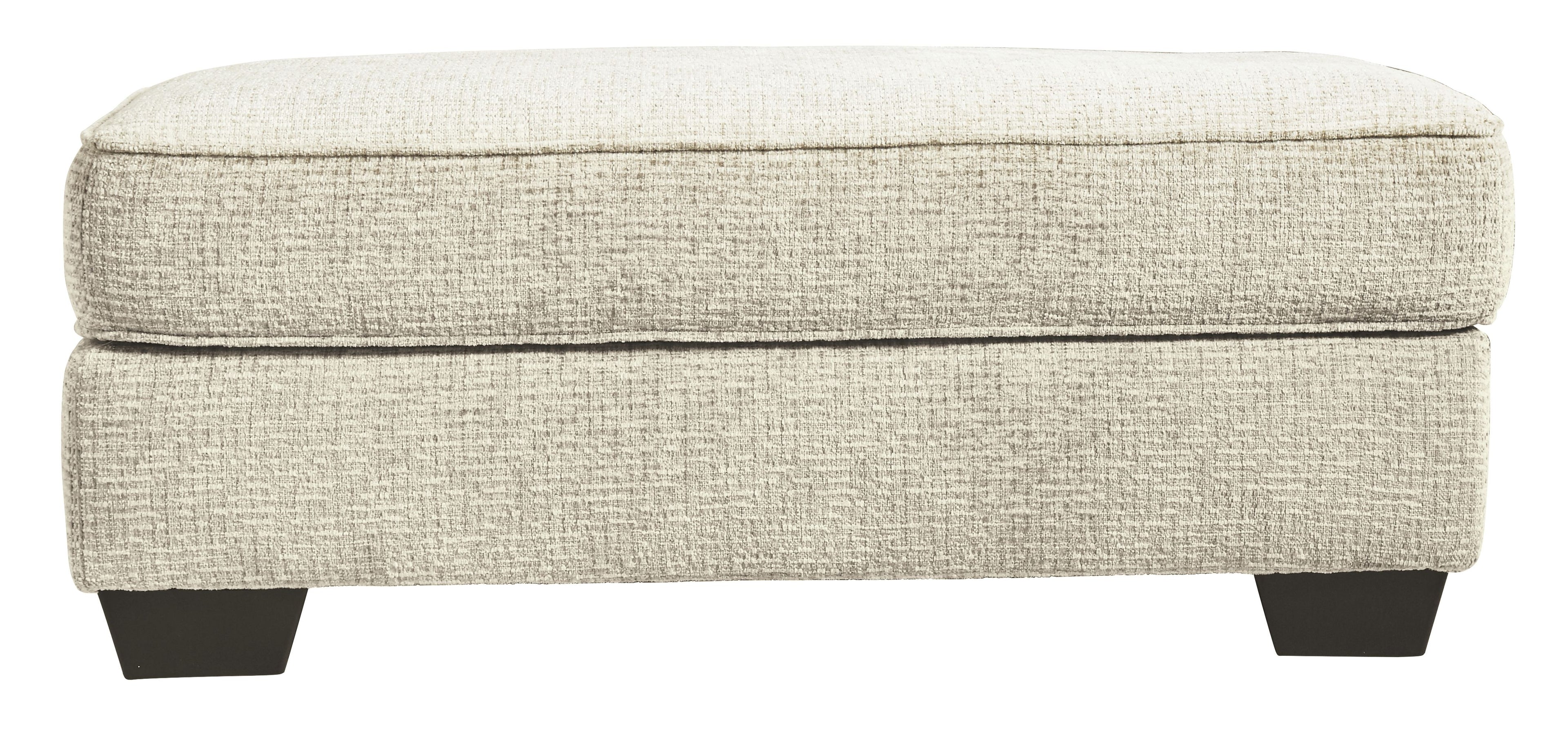 Sandstone upholstered ottoman with padded top and dark legs, side view