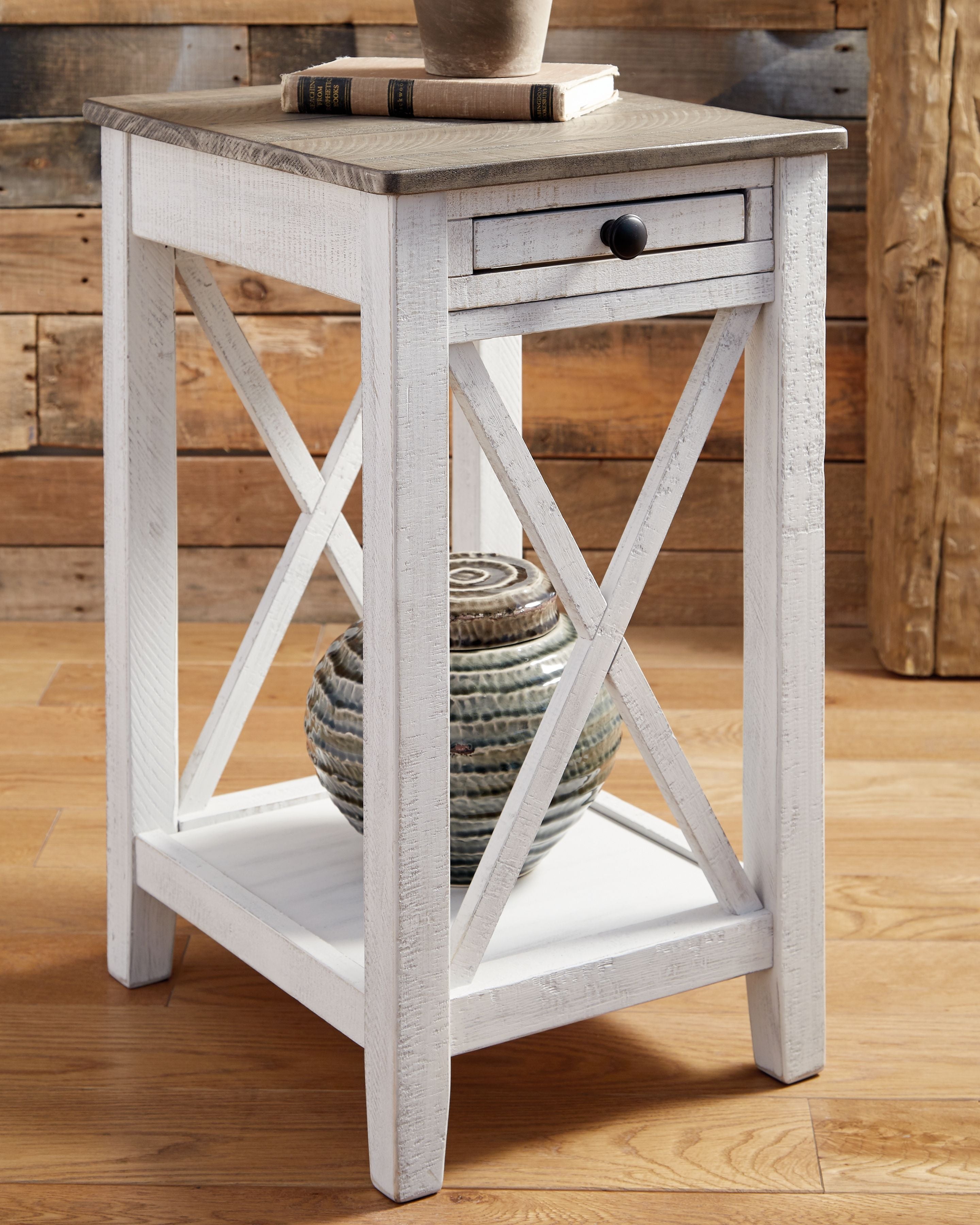 Accent table with drawer and X-style side supports, weathered white frame.