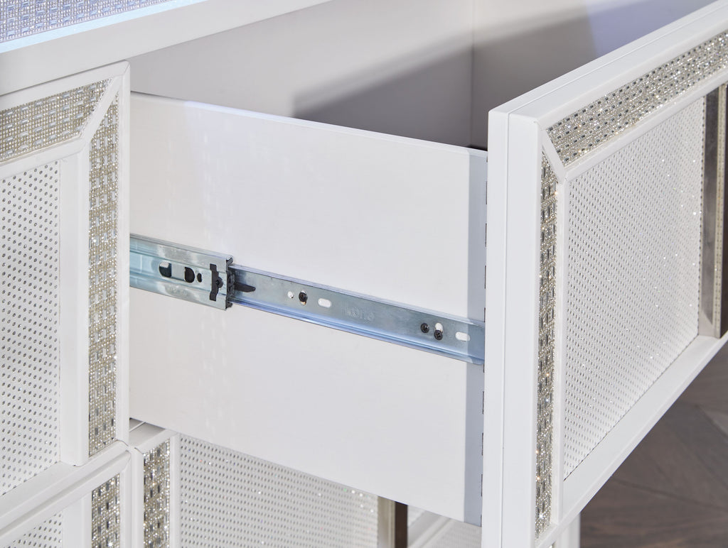 White dresser interior with metal rail and push-catch hardware