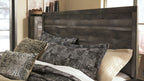 Gray wood panel bed with tall headboard and side rails, patterned pillows on mattress