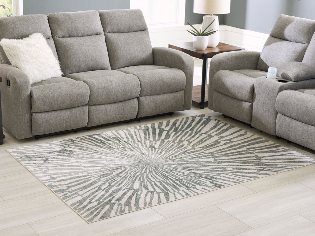 Gray and ivory washable area rug with radial sunburst motif in a living room setting