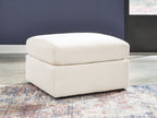 White upholstered accent ottoman with thick square arms and cushioned seat