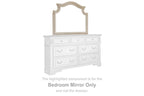 Bedroom mirror with arched white frame above dresser drawers, rectangular glass