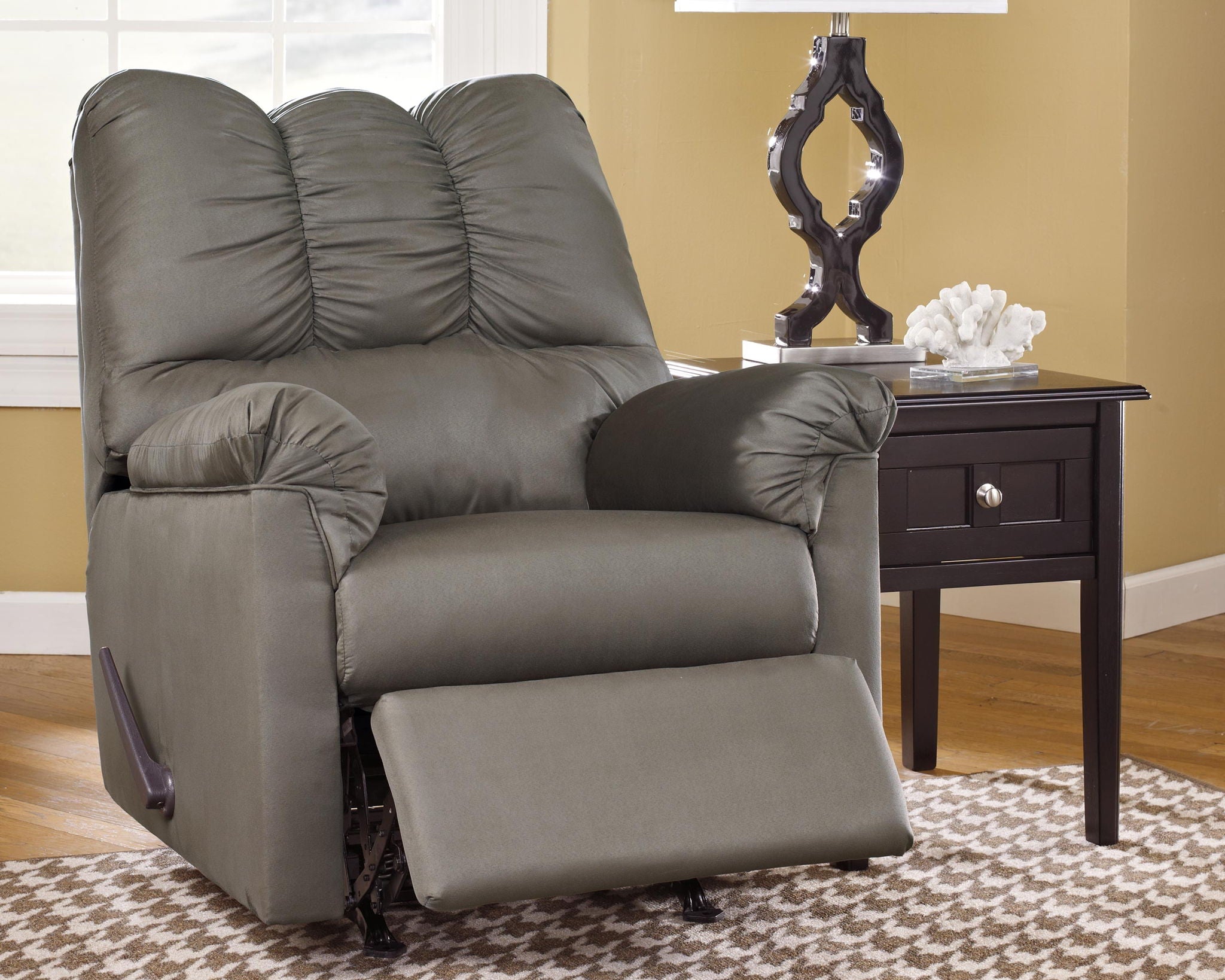Gray rocker recliner with extended ottoman footrest and tufted back cushions