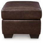 Dark brown upholstered ottoman with stitched seams and square block legs