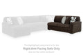 Chocolate-brown right-arm RAF sofa section with gray and patterned pillows, corded fabric.