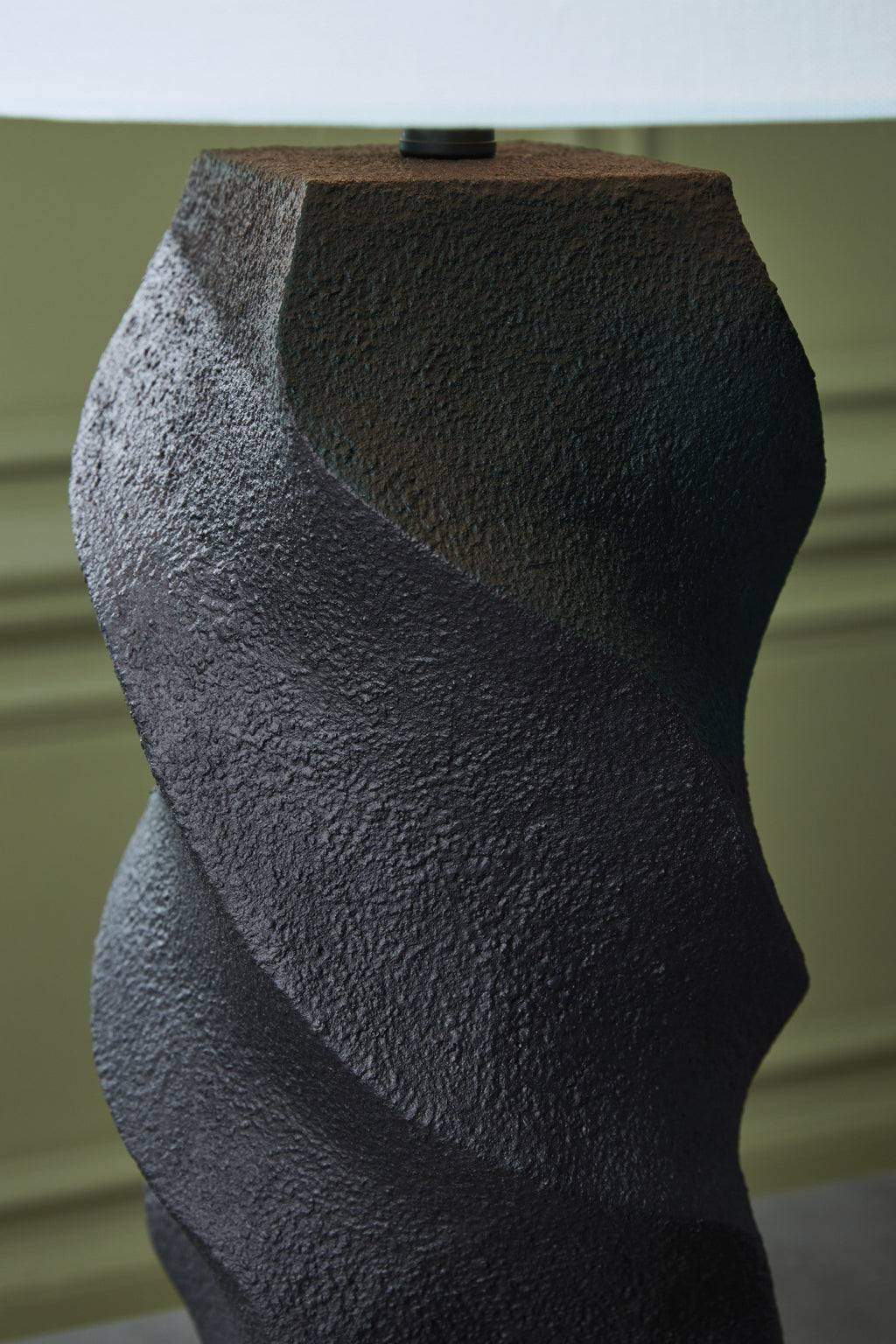 Close-up of black textured sculpted poly lamp base