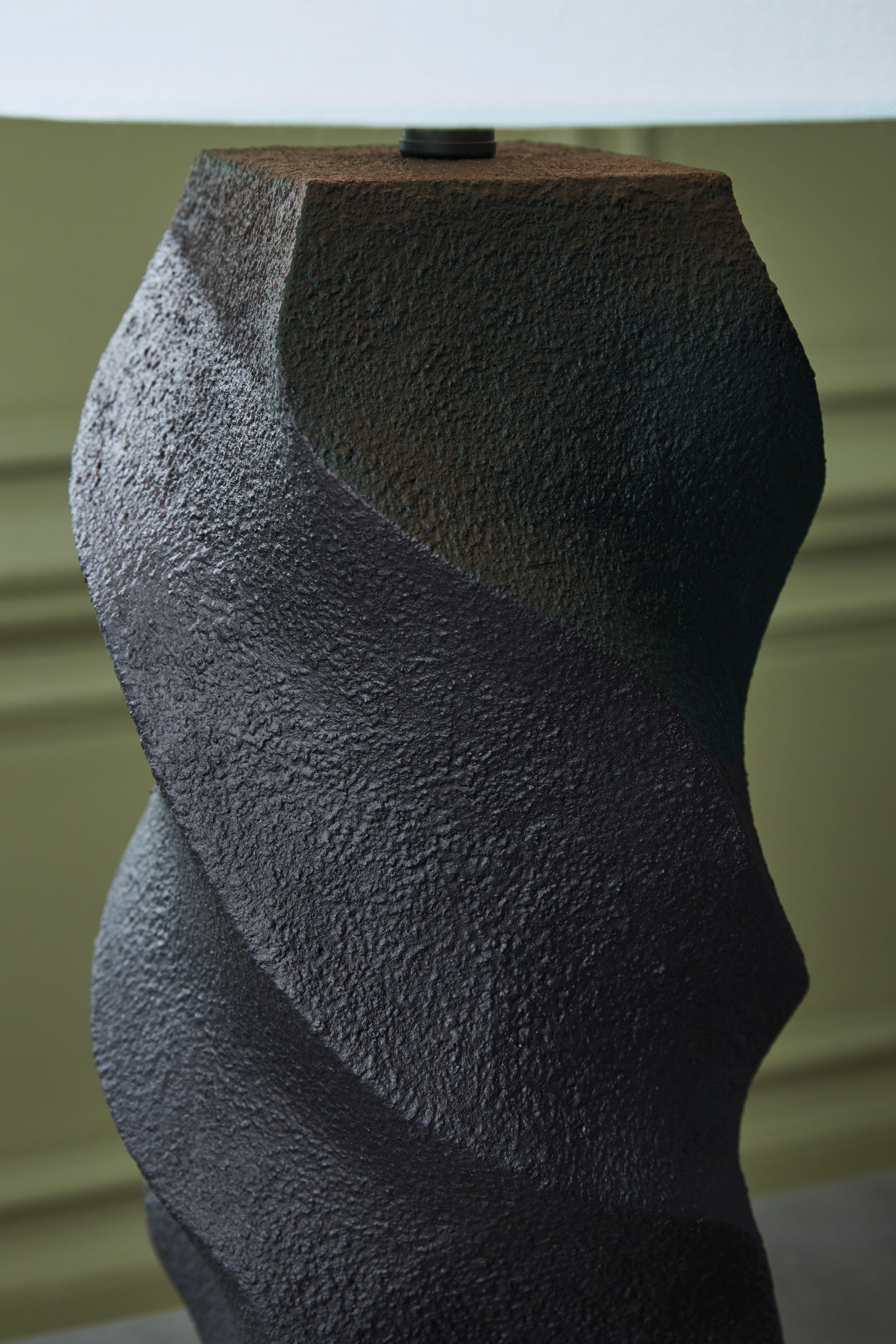 Close-up of black textured sculpted poly lamp base