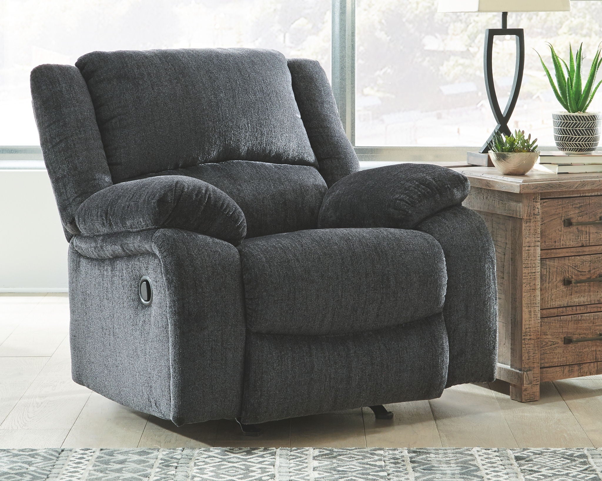 Slate fabric rocker recliner chair with headrest, padded arms, and side recline control